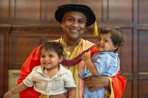 Photograph of Krish Majumdar with his twin boys at his graduation