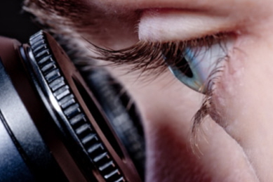 Generic image of a person looking through a microscope