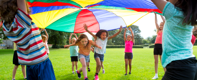Children running under cloth