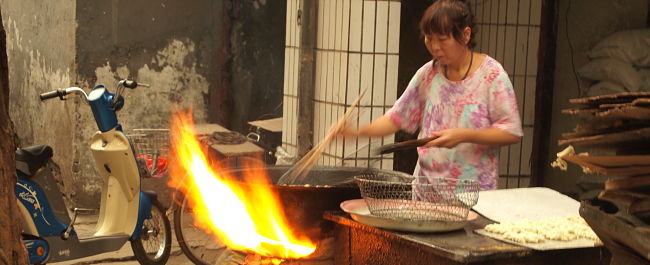 Lady cooking on BBQ