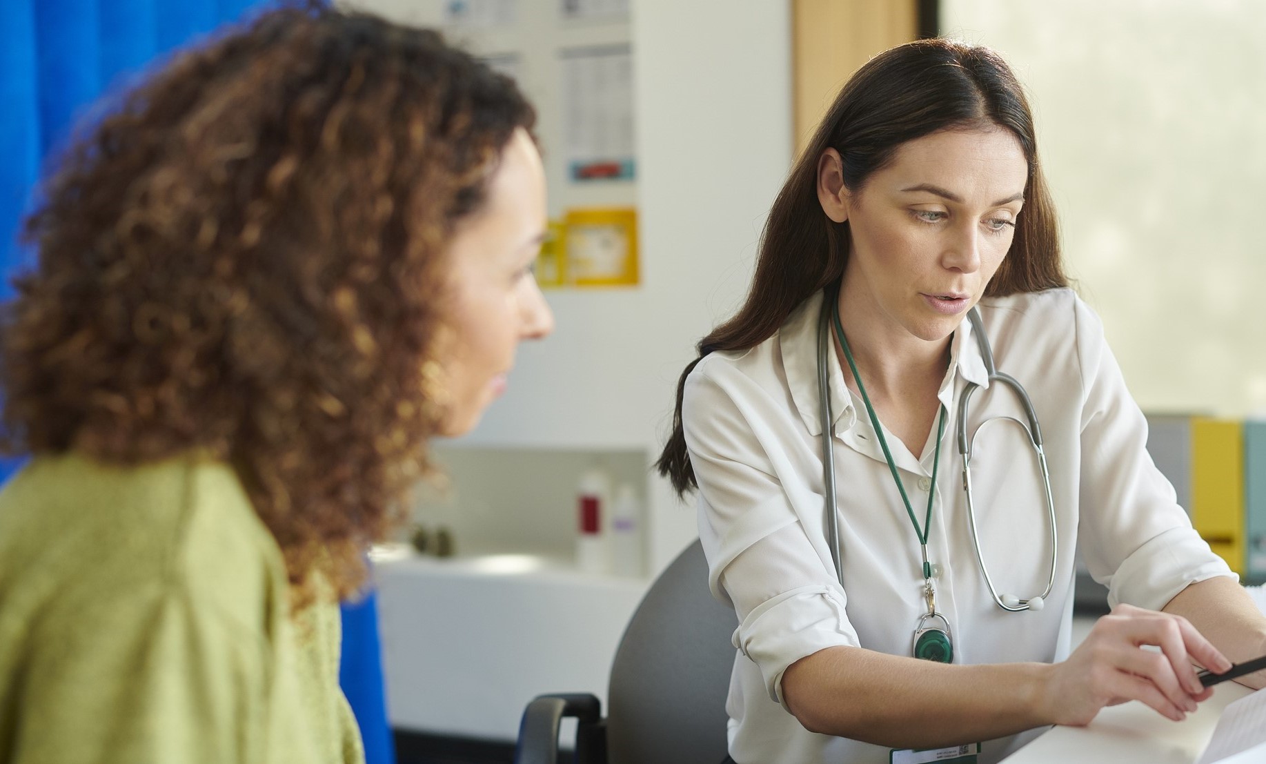 GP discussing test results with female patient