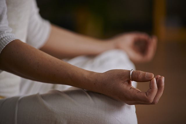 Person sitting in lotus position (hands on knees)