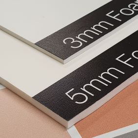 Image showing 2 examples of Foamex panels the panels have white backgrounds and are printed in black the panels are showing the edge thickness to illustrate the difference between the 3mm and 5mm options