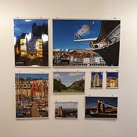 A wall display of Posters arranged to tesselate. the sizes range from A4 to A0 and show examples of the quality achieved form our machines and different paper stocks some having a silky and others high gloss effect. The subjects all being local such at the colourful houses in Hotwells and the view of the Clifton Suspension bridge and the SS Great Britain