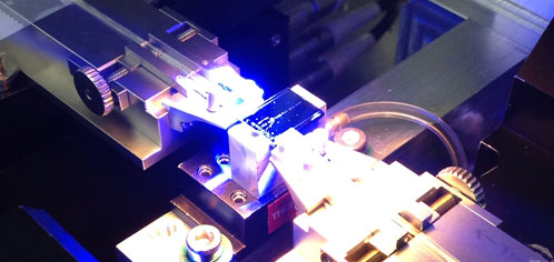 Photonic chip assembly equipment working on a chip.