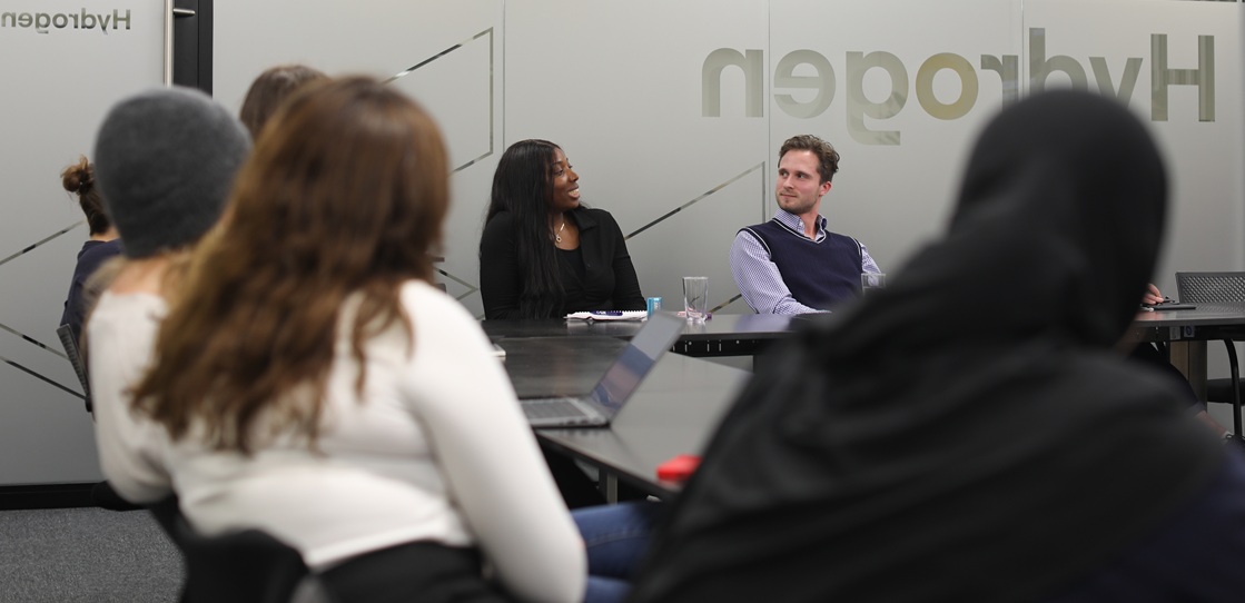 group sitting in conference room talking