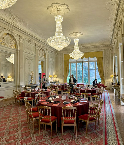 An ornate room with empty tables and chairs