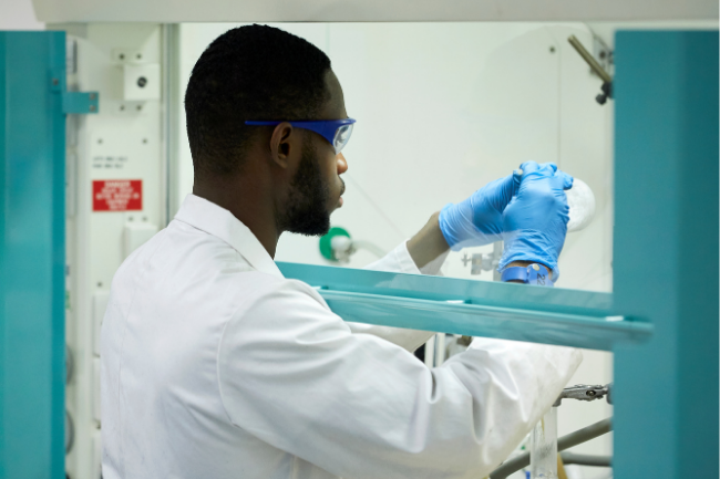 Chemistry student undertaking practical work with safety precautions