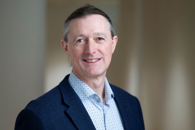 Professional photo of Aegis Professor Bryn Roberts smiling at the camera