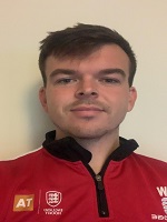 Portrait image of a man with dark hair wearing University of Bristol sports kit.