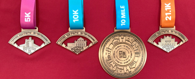 Bristol Run Series recycled zinc circular medals that display Bristol landmarks. Each medal has a colourful ribbon which states the event distance.