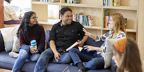 Three students having discussion in common room