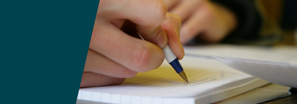 A banner showing someone writing.