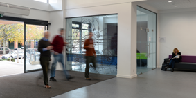 3 colleagues walking into a University building