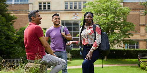 Three students happily chatting in Royal Fort Gardens