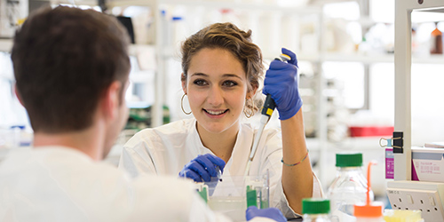 Students using pipettes in a laboratory.