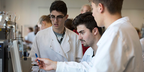 Three students work together in a laboratory class.
