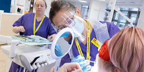 Students in the dental school working on a patient