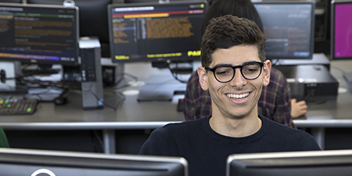 A student works on a computer using financial software