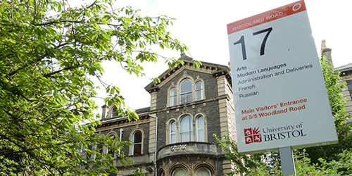 The outside of a University of Bristol building (17 Woodland Road) is surrounded by trees.