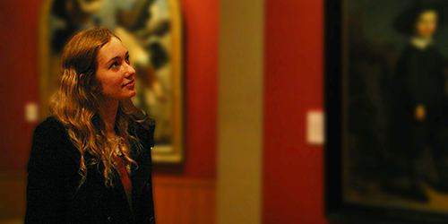 A person looking at a painting in a museum.