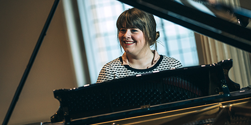 A person sitting at a piano.