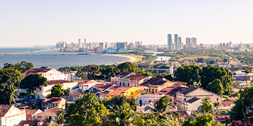 An aerial view of a city close to a beach and the sea.