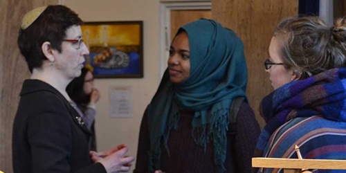 A group of people wearing differing religious clothing.