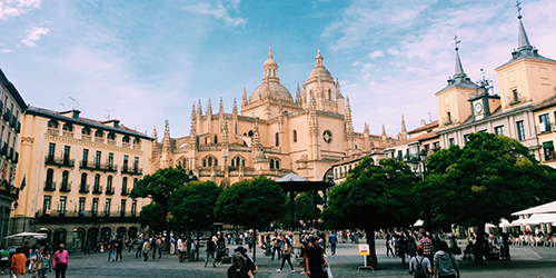 A city square surrounded by palatial architecture.