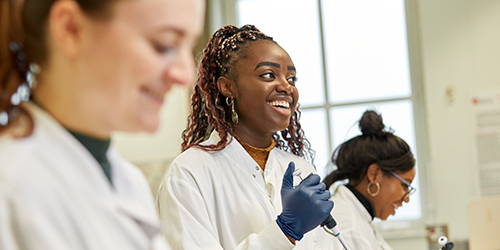 Three students in a science lab.