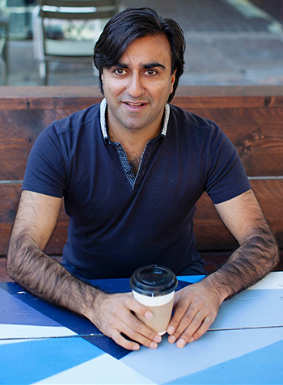 Adi Latif sat with a coffee