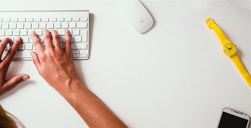 Hands typing on a keyboard
