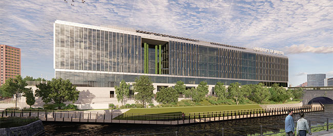 A large glass-fronted building overlooking a canal.