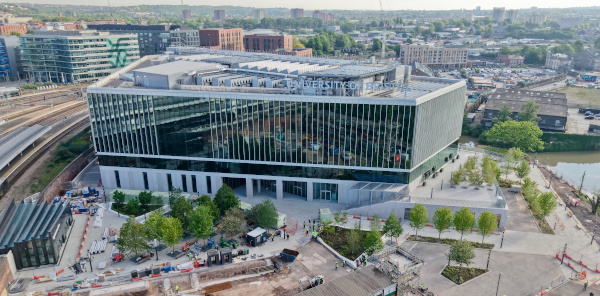 Ariel view over a large modern building, the city of Bristol can been seen in the background.