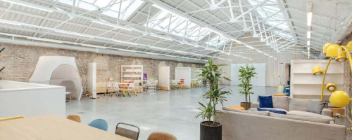 Large open-plan bright space with roof windows, desks and sofas