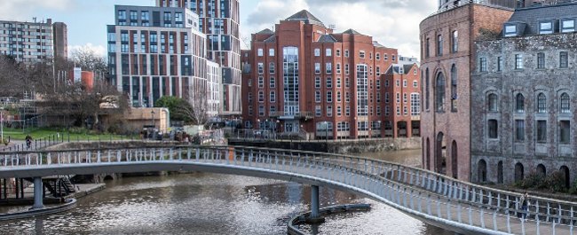 View of Bristol's Castle Park and surrounding buildings, with Castle Bridge over the river in the foreground.