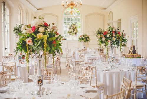 The Orangery set up with tables and flowers
