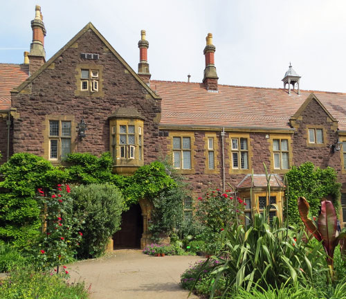 Exterior view of The Holmes. A period building with lush greenery.