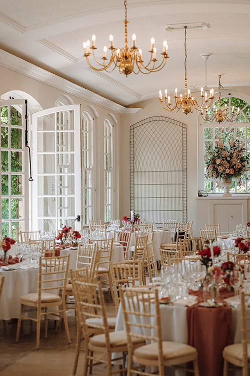 Tables and chairs with flowers on