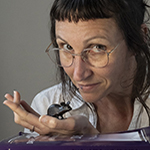 person with model mouse in hand