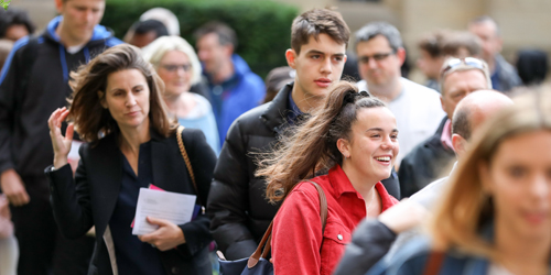 A photograph of multiple students in a crowd.